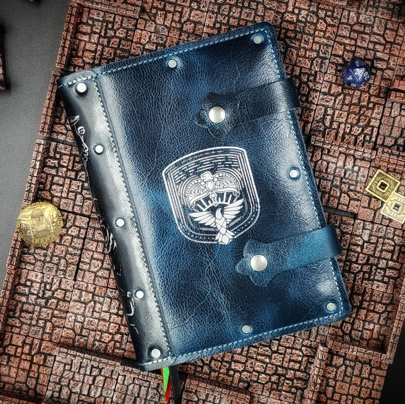 Handmade A5 leather adventure journal featuring a hand-gilded Ravenclaw eagle crest, Marauder's Map footprints, and a wand duel spine design by Grimbeard Leather