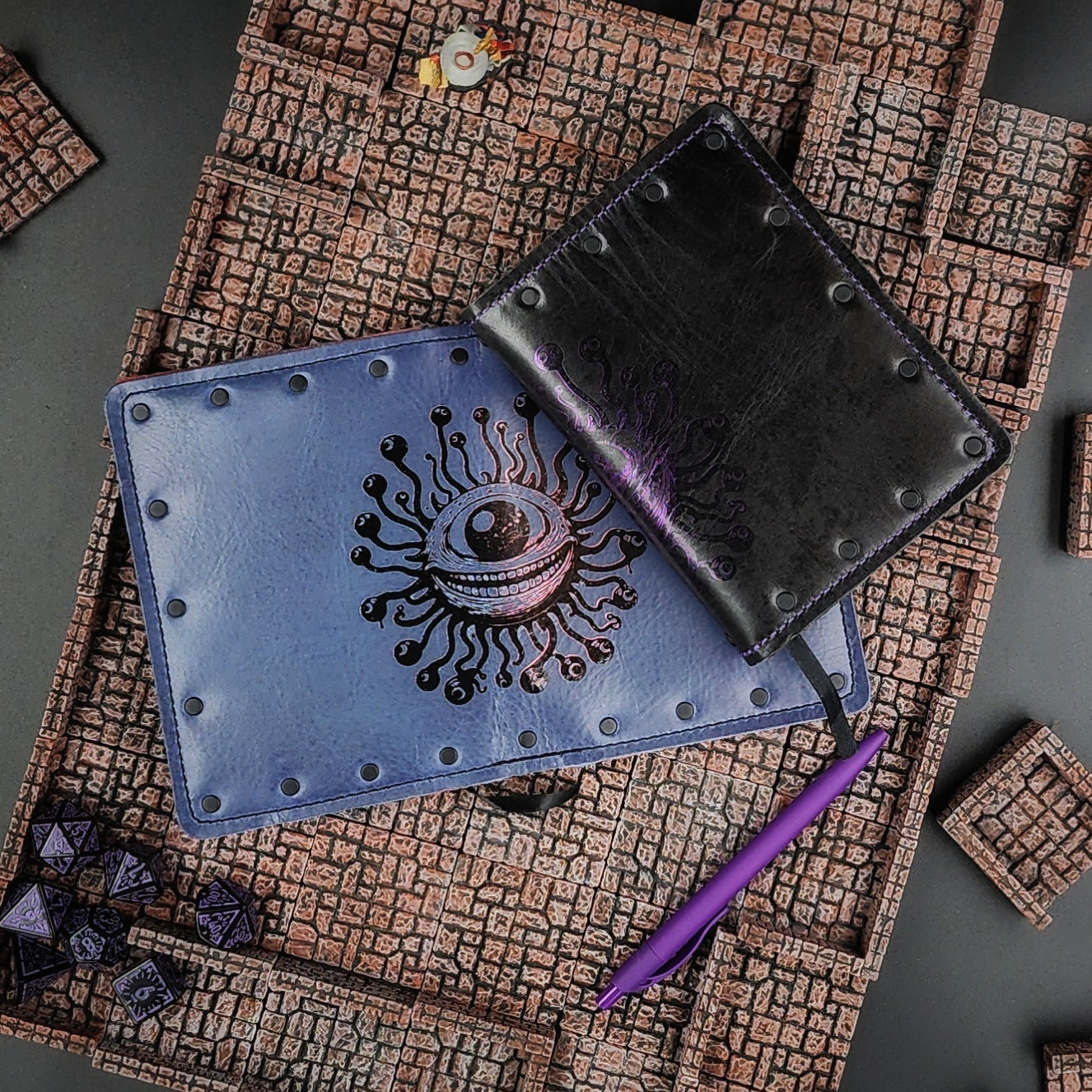 Custom handmade leather pocket journal with wraparound Beholder Eye Beast design on the spine and covers by Grimbeard Leather