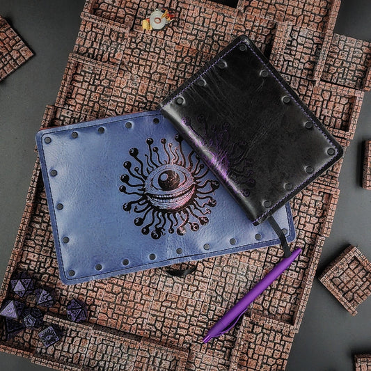 Custom handmade leather pocket journal with wraparound Beholder Eye Beast design on the spine and covers by Grimbeard Leather