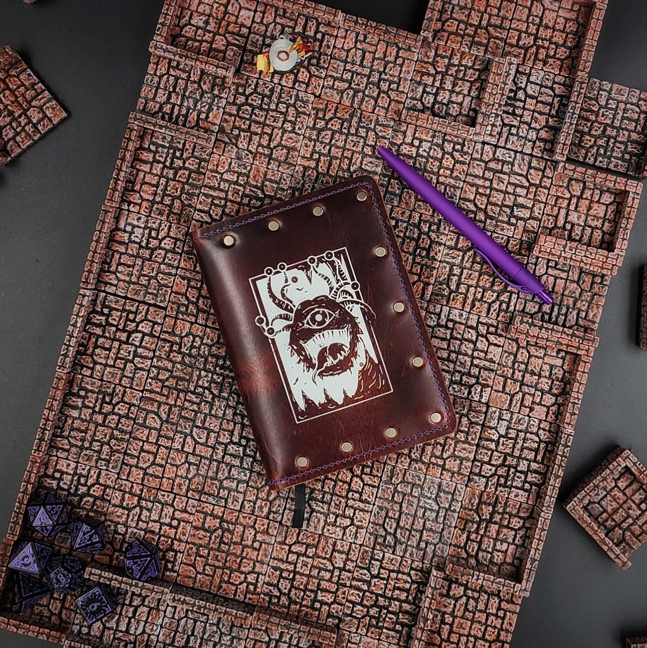 Custom handmade leather pocket journal with D&D Beholder inspired Eye Beast design by Grimbeard Leather