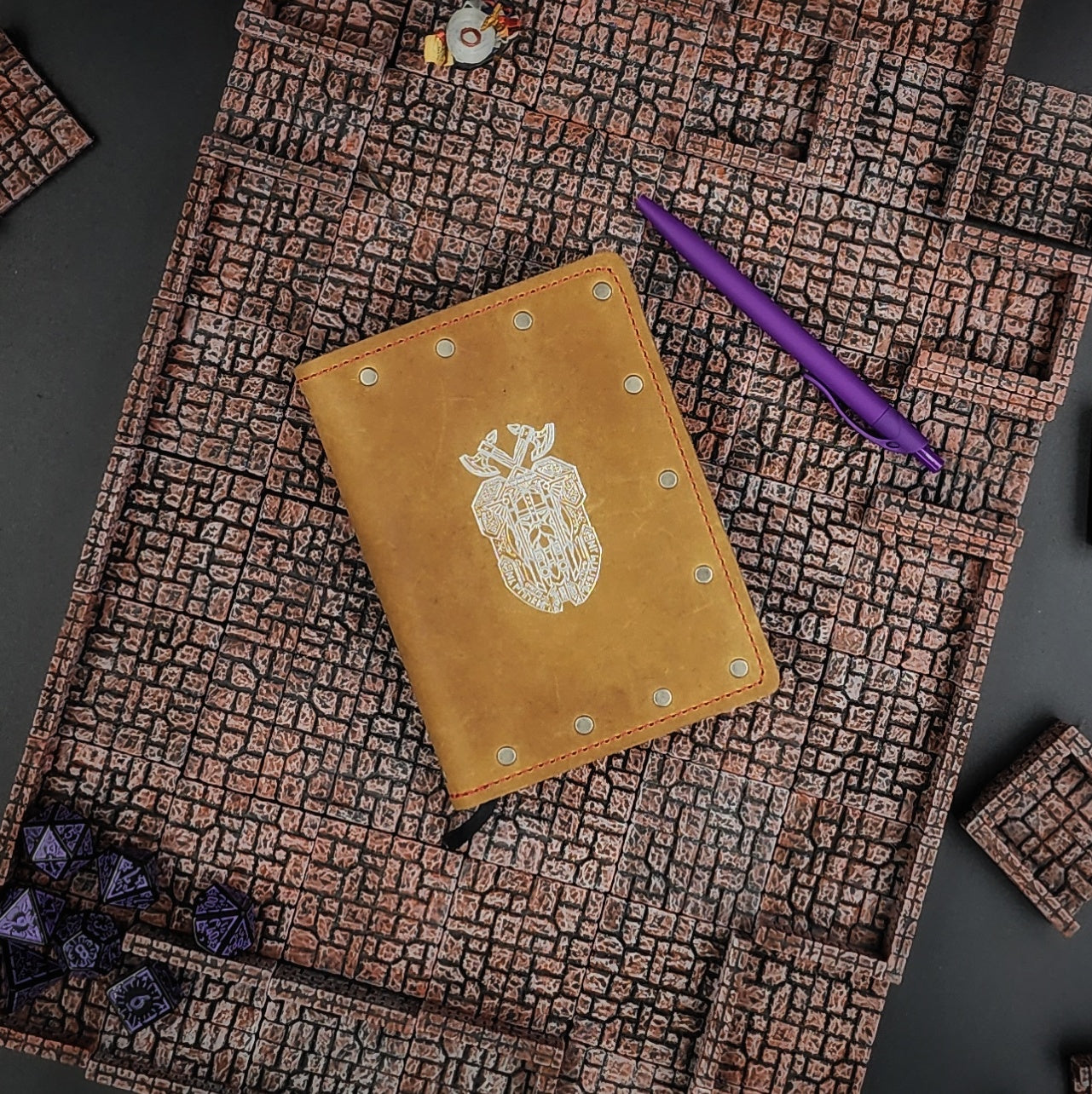 Custom handmade leather pocket journal with hand-gilded Dwarven shield and geometric knotwork design by Grimbeard Leather