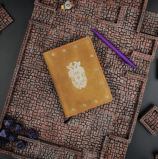 Custom handmade leather pocket journal with hand-gilded Dwarven shield and geometric knotwork design by Grimbeard Leather