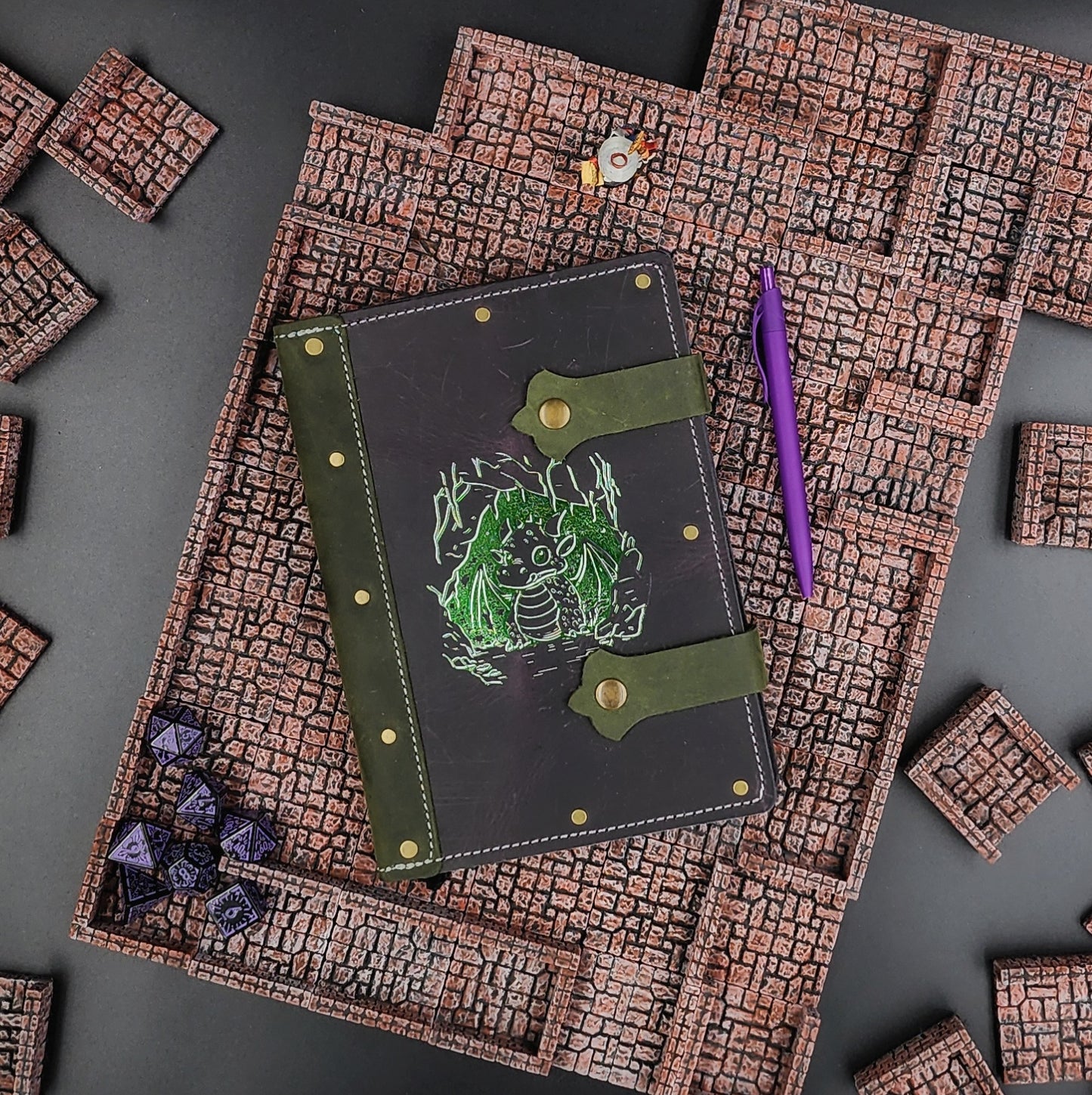 Handmade A5 leather adventure journal with hand-gilded baby dragon hatchling design by Grimbeard Leather