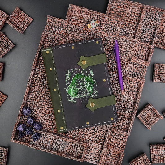 Handmade A5 leather adventure journal with hand-gilded baby dragon hatchling design by Grimbeard Leather