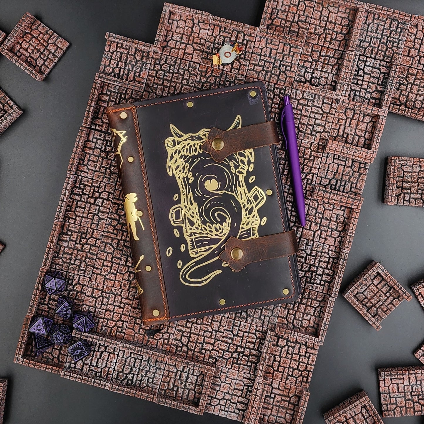 Handmade A5 leather adventure journal with hand-gilded Mimic gaping mouth design by Grimbeard Leather