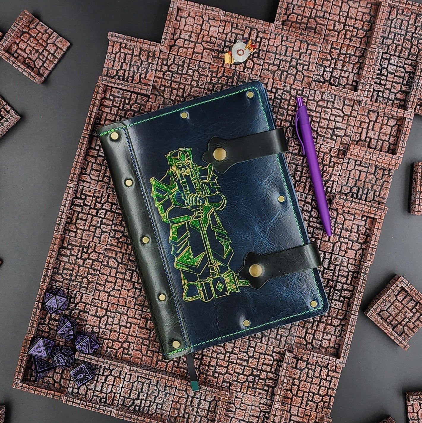 Handmade A5 leather adventure journal with hand-gilded dwarven statue and warhammer design by Grimbeard Leather