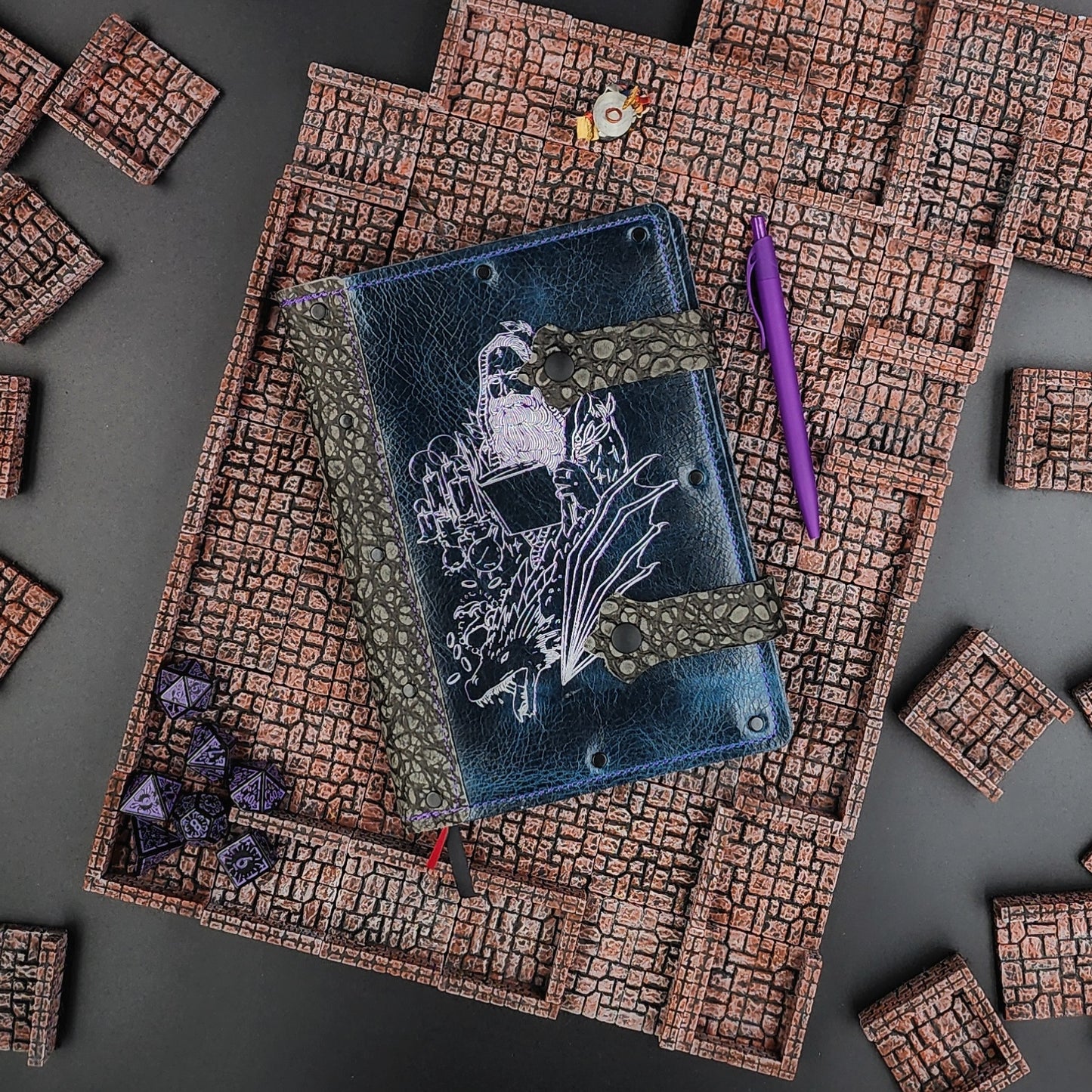 Handmade A5 leather adventure journal with hand-gilded wizard, dragon, and potion bottle design by Grimbeard Leather