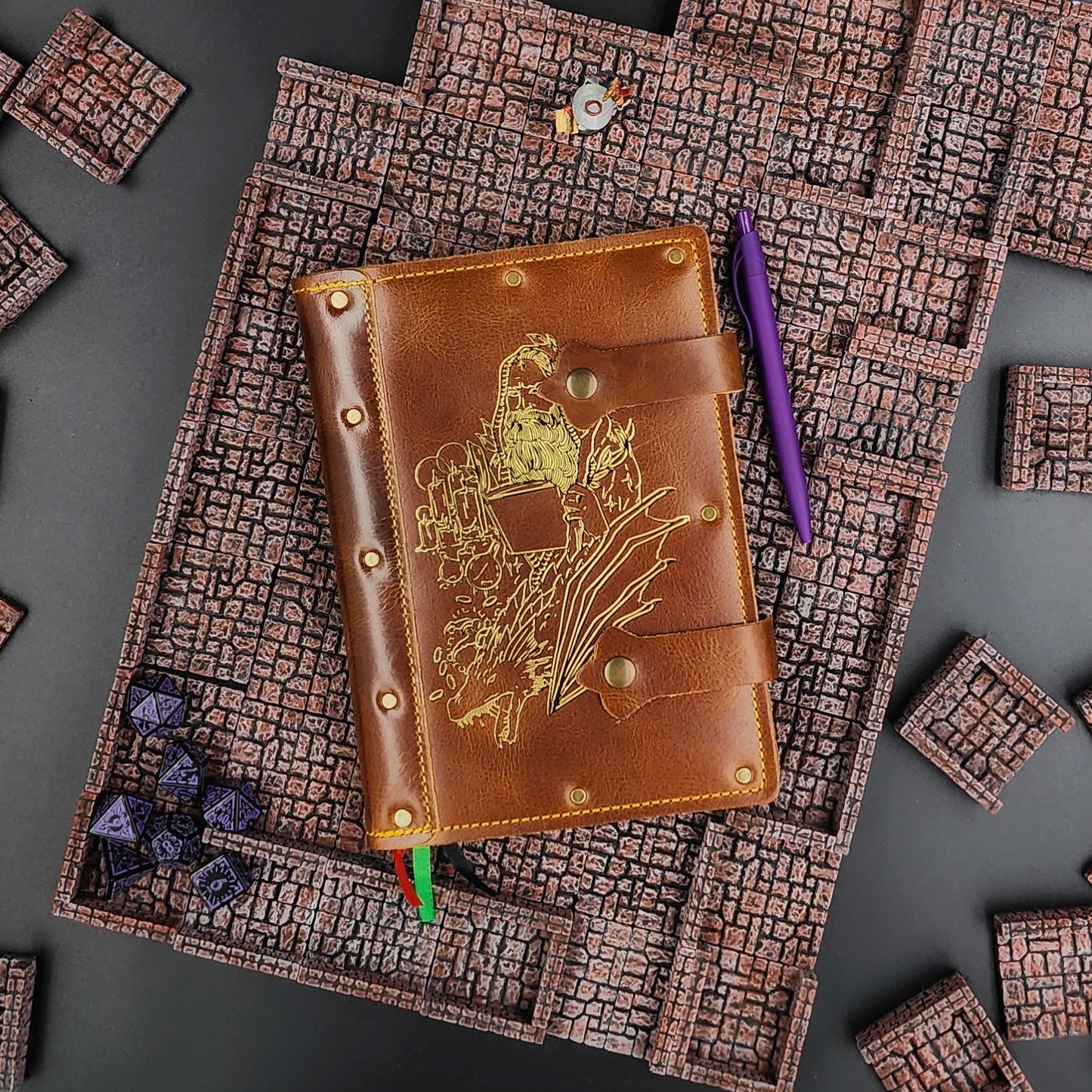 Handmade A5 leather adventure journal with hand-gilded wizard, dragon, and potion bottle design by Grimbeard Leather