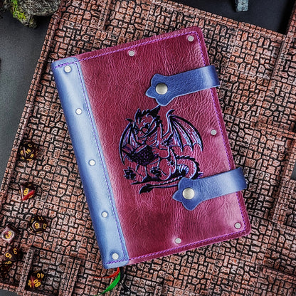Handmade A5 full-grain leather adventure journal with hand-gilded bookish dragon wearing glasses and reading design by Grimbeard Leather
