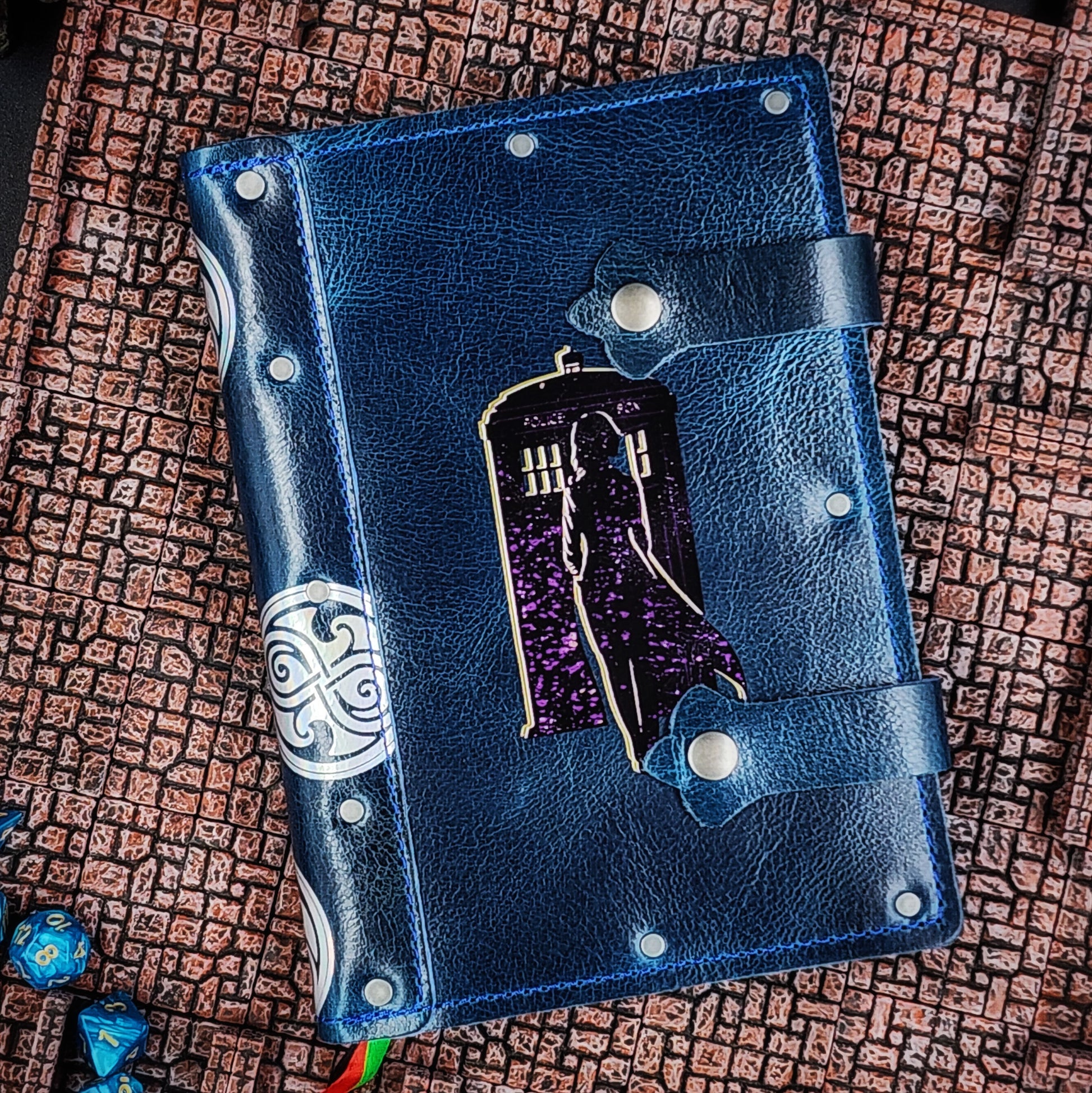 Handmade A5 leather adventure journal with hand-gilded woman, TARDIS, and Time Lord spine symbol design by Grimbeard Leather