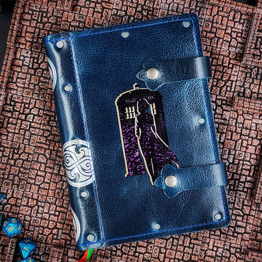 Handmade A5 leather adventure journal with hand-gilded woman, TARDIS, and Time Lord spine symbol design by Grimbeard Leather