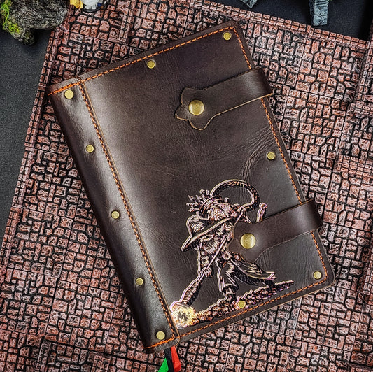 Handmade A5 leather adventure journal with hand-gilded original design of Grimbeard the Wizard using a vacuum backpack to collect treasure by Grimbeard Leather