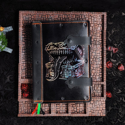 Handmade A5 leather adventure journal with hand-gilded treasure chest mimic monster design by Grimbeard Leather