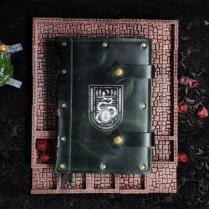 Handmade A5 leather adventure journal featuring a hand-gilded Slytherin serpent crest, Marauder's Map footprints, and a wand duel spine design by Grimbeard Leather
