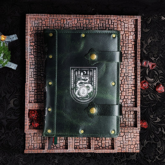 Handmade A5 leather adventure journal featuring a hand-gilded Slytherin serpent crest, Marauder's Map footprints, and a wand duel spine design by Grimbeard Leather