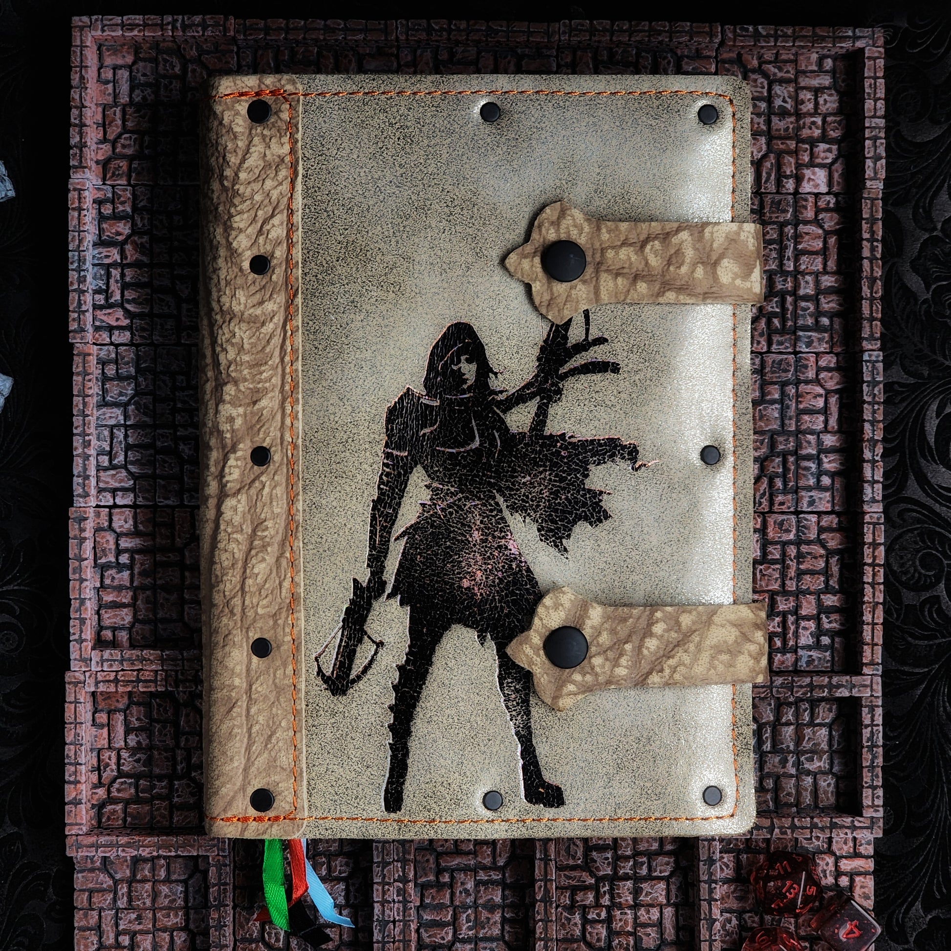 Handmade A5 leather adventure journal with hand-gilded hooded female rogue with crossbow design by Grimbeard Leather