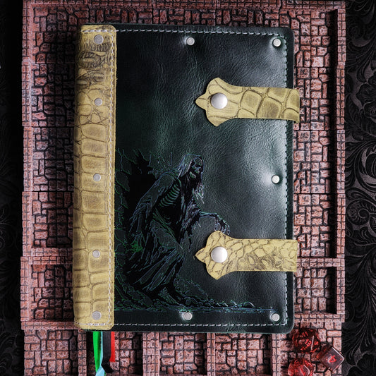 Handmade A5 leather adventure journal featuring a hand-gilded Acererak the Lich walking out of the spine design by Grimbeard Leather