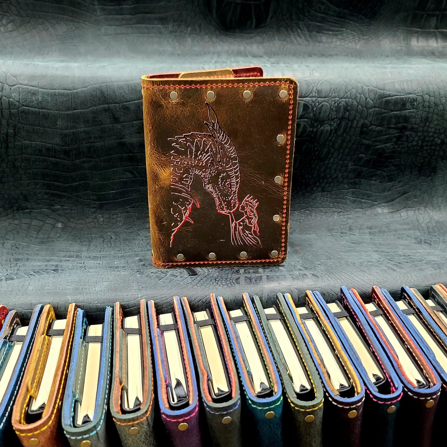 Custom handmade leather pocket journal with dragon head and crowned woman monarch design by Grimbeard Leather