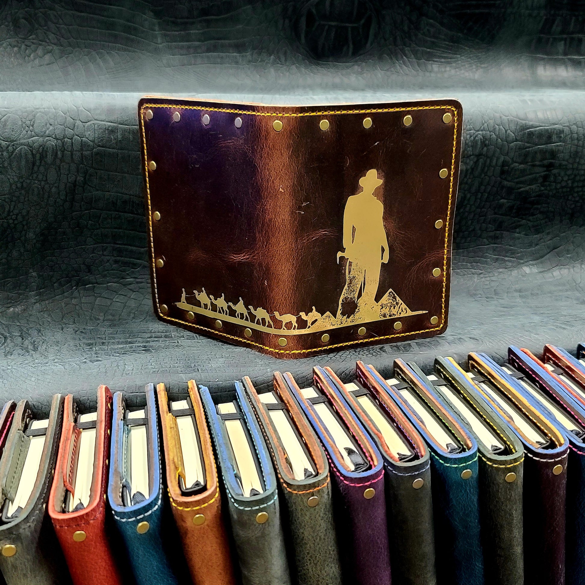 Custom handmade leather pocket journal with Indiana Jones silhouette, Great Pyramids, and camel caravan design by Grimbeard Leather
