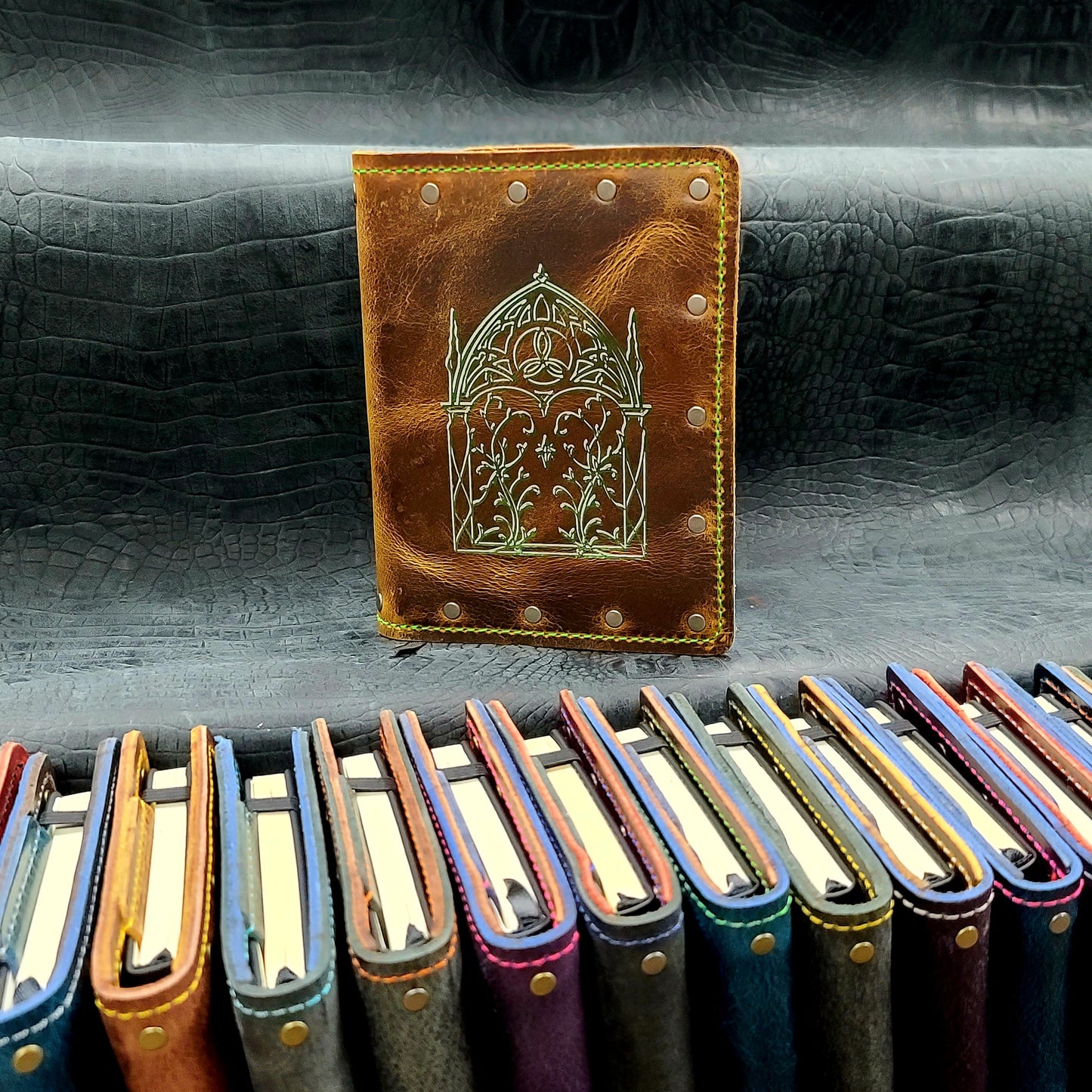 Custom handmade leather pocket journal with hand-gilded Elven Gothic arch and intricate leaf linework design by Grimbeard Leather