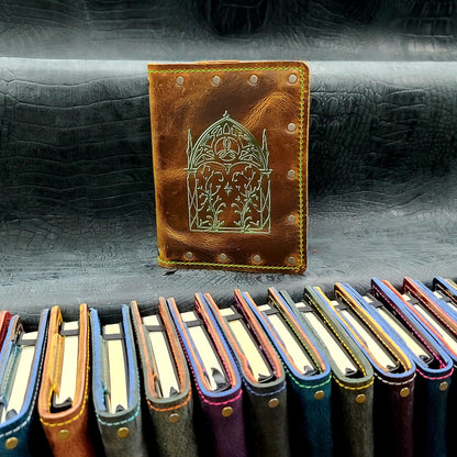 Custom handmade leather pocket journal with hand-gilded Elven Gothic arch and intricate leaf linework design by Grimbeard Leather