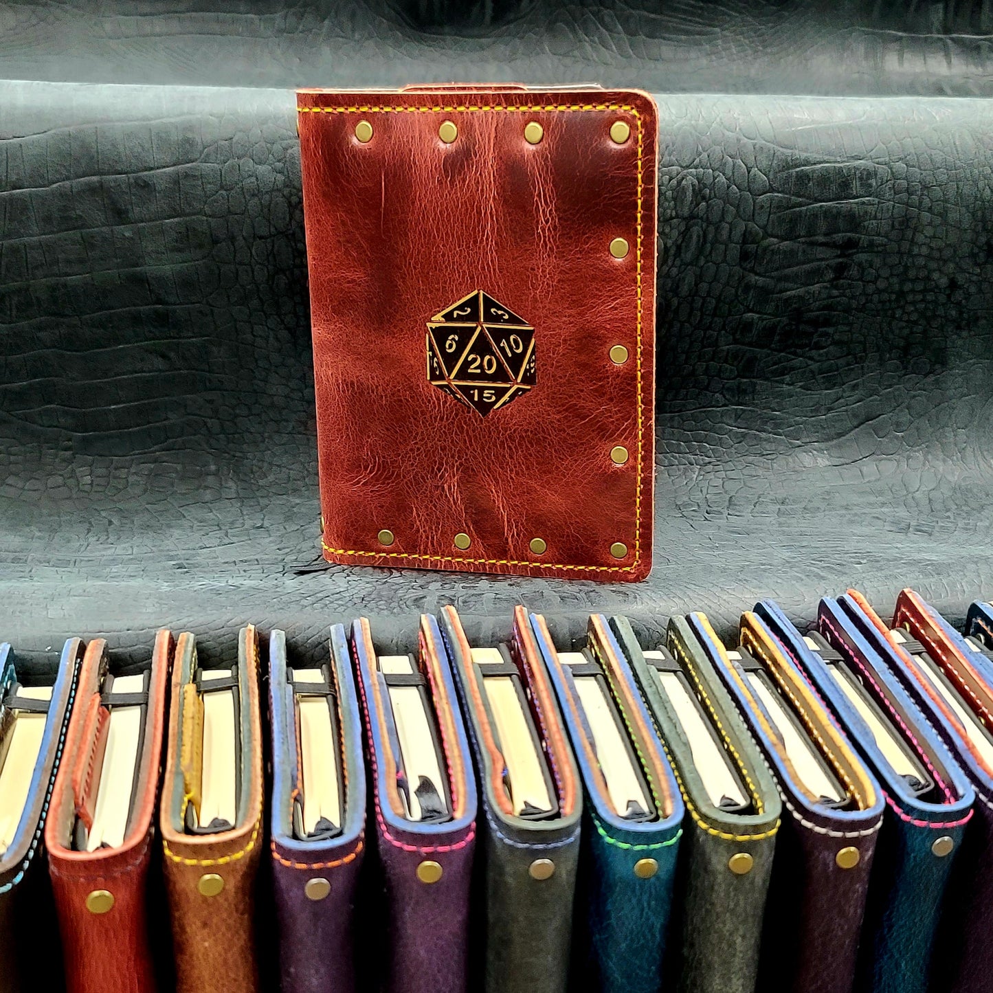 Custom handmade leather pocket journal with hand-gilded 20-sided die D20 design by Grimbeard Leather
